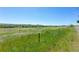 Expansive open field featuring native grasses and mountain views, offering a serene and natural landscape at 7801 Valley View St, Louviers, CO 80131