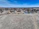 Large, undeveloped lot featuring a pond and neighborhood views under a blue sky at 6068 W Utah Ln, Lakewood, CO 80232