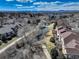 Aerial view of townhome community with paths, pond, and mountain views at 6068 W Utah Ln, Lakewood, CO 80232