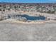 An aerial shot of a pond surrounded by grassland and trees at 6068 W Utah Ln, Lakewood, CO 80232