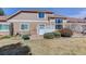 Back of home and backyard area with grass, patio and shrubs at 6068 W Utah Ln, Lakewood, CO 80232