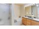 Bathroom featuring double sinks, separate tub, and shower with glass door at 6068 W Utah Ln, Lakewood, CO 80232