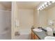 Bright bathroom with a dual sink vanity, soaking tub, and glass-enclosed shower for a spa-like experience at 6068 W Utah Ln, Lakewood, CO 80232