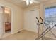 Bedroom featuring a large window, ceiling fan, and workout equipment at 6068 W Utah Ln, Lakewood, CO 80232