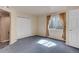 Bedroom with natural light, large closet, neutral carpet, and ensuite bathroom at 6068 W Utah Ln, Lakewood, CO 80232