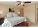 Cozy bedroom featuring a white bed, ceiling fan, and natural light at 6068 W Utah Ln, Lakewood, CO 80232