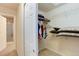 Walk-in closet with wire shelving and ample space for clothes and storage with access to the ensuite bathroom at 6068 W Utah Ln, Lakewood, CO 80232