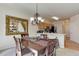 Cozy dining area with chandelier lighting, adjacent to the kitchen, perfect for Gathering meals at 6068 W Utah Ln, Lakewood, CO 80232