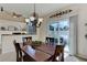 Dining room features chandelier, table and view of exterior deck at 6068 W Utah Ln, Lakewood, CO 80232