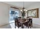 Dining room with chandelier, table, gold mirror and sliding door at 6068 W Utah Ln, Lakewood, CO 80232