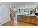 Bright kitchen with stainless steel appliances, hardwood floors, and a view into the dining area and second floor at 6068 W Utah Ln, Lakewood, CO 80232