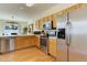 Spacious kitchen features stainless steel appliances and wood flooring at 6068 W Utah Ln, Lakewood, CO 80232