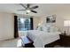 Bedroom with a ceiling fan, big window, and furnishings creating a relaxing retreat at 6068 W Utah Ln, Lakewood, CO 80232