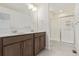 Bathroom with double sinks, granite countertops, and glass-enclosed shower at 21821 E 7Th Ave, Aurora, CO 80018