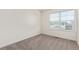 Bright bedroom featuring neutral carpet, white trim, and a window allowing natural light at 21821 E 7Th Ave, Aurora, CO 80018