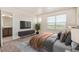 Bright bedroom with large window and TV; open door to bathroom at 21821 E 7Th Ave, Aurora, CO 80018