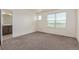 Sunlit bedroom featuring plush carpeting, a neutral color palette, and adjacent bathroom at 21821 E 7Th Ave, Aurora, CO 80018