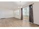 Bright dining room area showcasing wood floors, sliding glass doors to the back, and lots of natural light at 21821 E 7Th Ave, Aurora, CO 80018