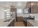 Modern kitchen featuring granite countertops, stainless steel appliances, and lots of storage at 21821 E 7Th Ave, Aurora, CO 80018