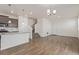 Bright and airy living space featuring modern flooring, stairs to the second floor, and access to the kitchen at 21821 E 7Th Ave, Aurora, CO 80018