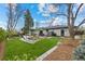 Expansive backyard with patio areas, lush lawn, and mature trees at 2905 Regis Dr, Boulder, CO 80305
