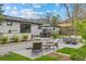 Beautiful backyard patio featuring an outdoor kitchen, seating, and lush landscaping at 2905 Regis Dr, Boulder, CO 80305