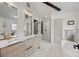 Bright bathroom featuring double vanity, soaking tub, and walk in shower at 2905 Regis Dr, Boulder, CO 80305