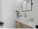 Modern powder room with vessel sink, sleek fixtures, and hardwood cabinets at 2905 Regis Dr, Boulder, CO 80305