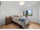 Cozy bedroom with hardwood floors, a large window, and warm lighting at 2905 Regis Dr, Boulder, CO 80305