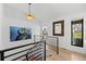 Bright hallway with modern railings, hardwood floors, and stylish decor at 2905 Regis Dr, Boulder, CO 80305