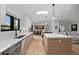 Bright open kitchen boasts modern lighting, gas cooktop, island, and breakfast bar seating at 2905 Regis Dr, Boulder, CO 80305