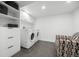 Well-organized laundry room featuring modern washer, dryer, storage cabinets, and shelving at 2905 Regis Dr, Boulder, CO 80305