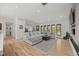 Spacious living room featuring hardwood floors, large windows, and ample seating at 2905 Regis Dr, Boulder, CO 80305