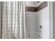 Updated bathroom featuring tiled shower and tub combination with modern fixtures and a shower curtain at 3778 Happyheart Way, Castle Rock, CO 80109