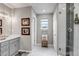 This bathroom features a vanity with storage, a modern shower with black and white tile, and comfortable lighting at 3778 Happyheart Way, Castle Rock, CO 80109