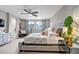 Comfortable bedroom offering a spacious layout, soft lighting, and a beautiful view from the nearby windows at 3778 Happyheart Way, Castle Rock, CO 80109