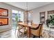Dining area featuring a wooden table, modern light fixture, and sliding glass door to the backyard at 3778 Happyheart Way, Castle Rock, CO 80109