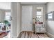 Neutral entryway with a white front door, wood flooring, mirror and cabinet at 3778 Happyheart Way, Castle Rock, CO 80109