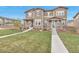 Charming townhome with stone accents, inviting front porch, and well-maintained lawn at 3778 Happyheart Way, Castle Rock, CO 80109