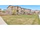 Well-maintained townhomes with lush green lawns in a Gathering-friendly neighborhood at 3778 Happyheart Way, Castle Rock, CO 80109
