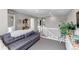 Relaxing upstairs living room features gray sofa and adjacent staircase with white railing at 3778 Happyheart Way, Castle Rock, CO 80109