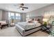 Bright and airy main bedroom with seating, large windows, and stylish decor at 3778 Happyheart Way, Castle Rock, CO 80109