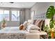 Main bedroom featuring neutral tones, large windows, and stylish furnishings at 3778 Happyheart Way, Castle Rock, CO 80109