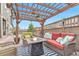 Relaxing outdoor patio with a cozy fire pit, stylish furniture, and a charming pergola at 3778 Happyheart Way, Castle Rock, CO 80109