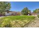 Fenced backyard featuring deck, lush lawn and playground at 6010 S Garland Way, Littleton, CO 80123