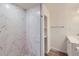 Bathroom featuring walk-in shower with marble tile and vanity at 6010 S Garland Way, Littleton, CO 80123