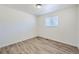 A bright bedroom, with new floor, offers a serene retreat with fresh paint and ample natural light at 6010 S Garland Way, Littleton, CO 80123