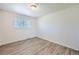Comfortable bedroom with new floors and fresh paint, featuring new window allowing ample natural light at 6010 S Garland Way, Littleton, CO 80123