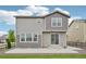 Back exterior featuring neutral siding, a sliding glass door, a concrete patio, and a grass lawn at 12854 Clearview St, Firestone, CO 80504