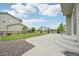 View of a well-maintained backyard with a concrete patio, lush lawn, gravel bed, and wooden fence at 12854 Clearview St, Firestone, CO 80504